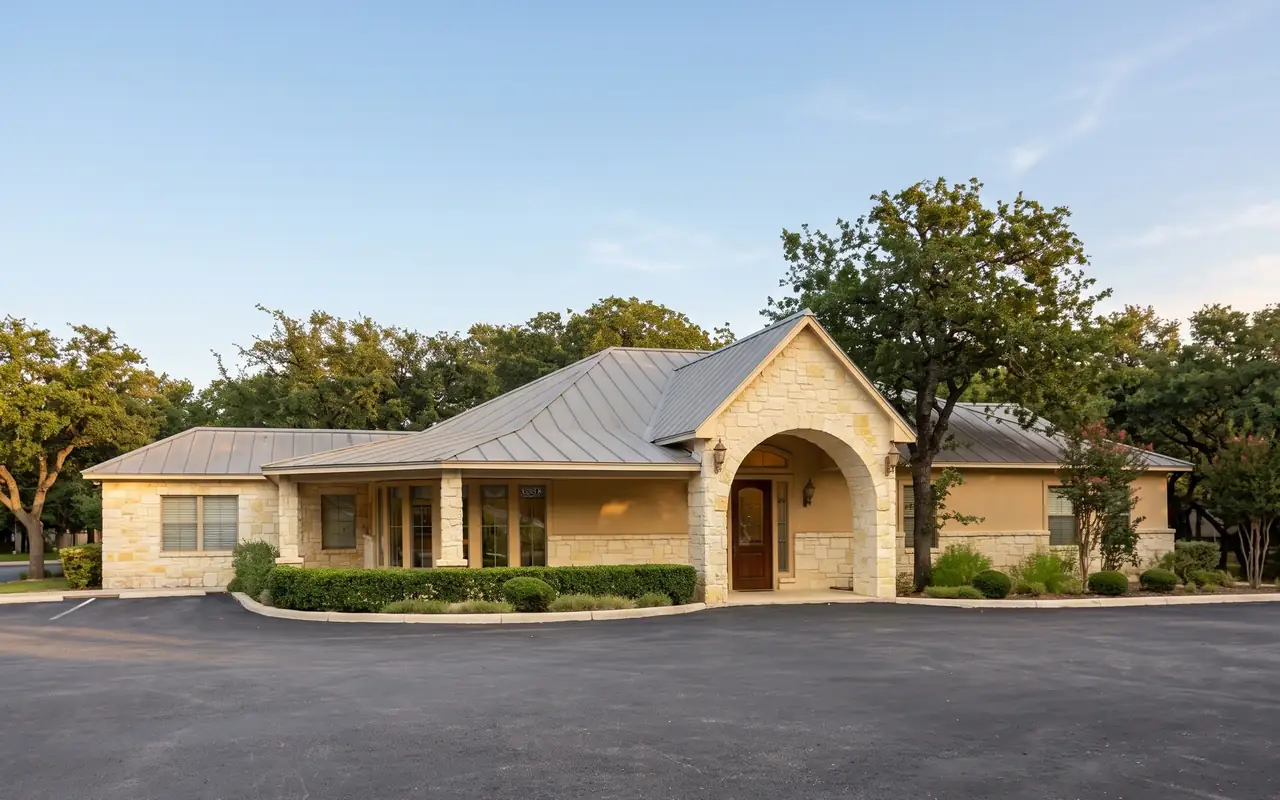 The Boerne Dental Center building on I-10 West in Boerne, Texas: Hill Country limestone, a standing-seam roof and an arched stone entry.