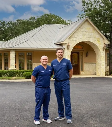 Dr. Simpson and Dr. Vesta in the car park in front of the Boerne Dental Center building.